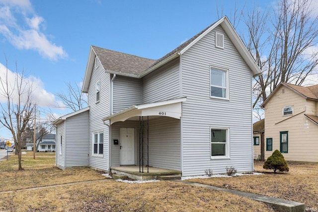 view of front of house featuring a shingled roof and covered porch