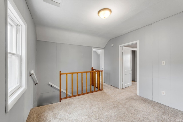 interior space featuring carpet floors and lofted ceiling