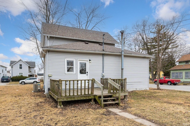 back of house featuring a shingled roof, a deck, and cooling unit