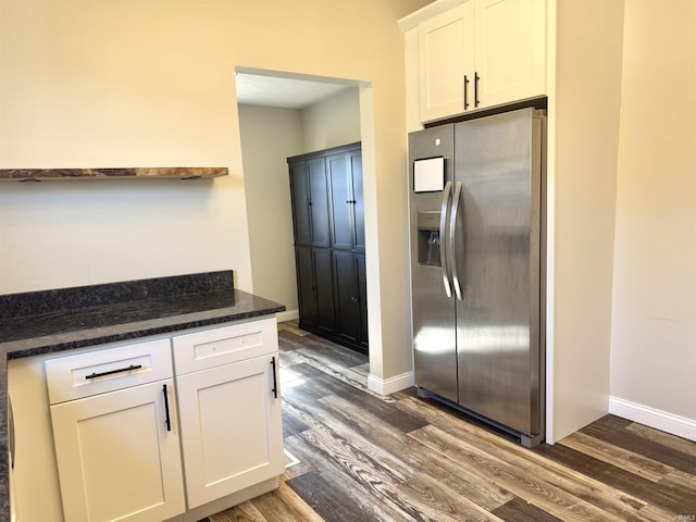 kitchen featuring baseboards, white cabinets, dark stone countertops, dark wood-style flooring, and stainless steel refrigerator with ice dispenser