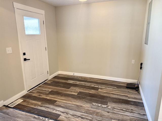 foyer with baseboards, visible vents, and dark wood finished floors