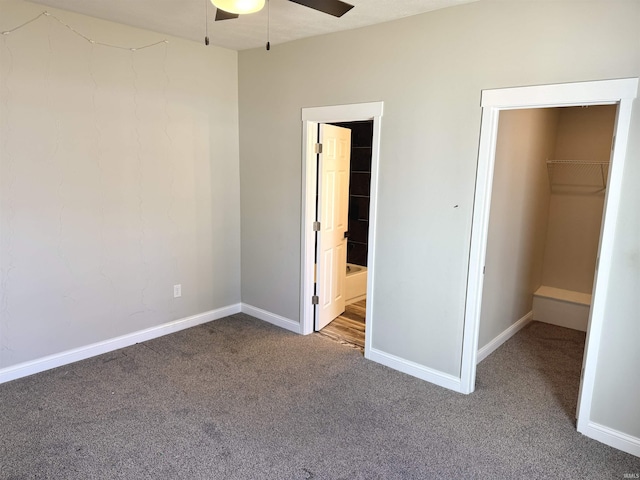 unfurnished bedroom featuring carpet floors, ceiling fan, ensuite bath, and baseboards