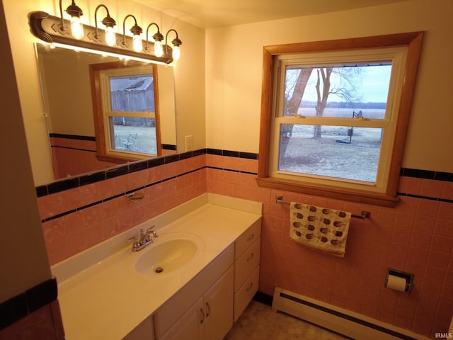 bathroom featuring wainscoting, a baseboard radiator, tile walls, and vanity