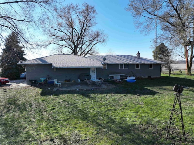 back of house featuring a patio and a lawn