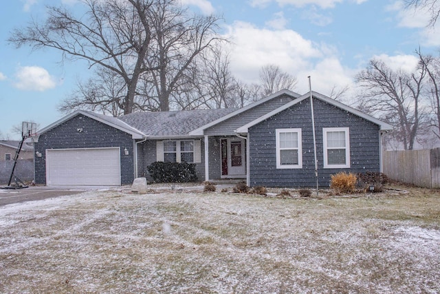 view of front of property with a garage, driveway, and fence