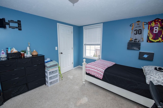 bedroom with a textured ceiling and baseboards