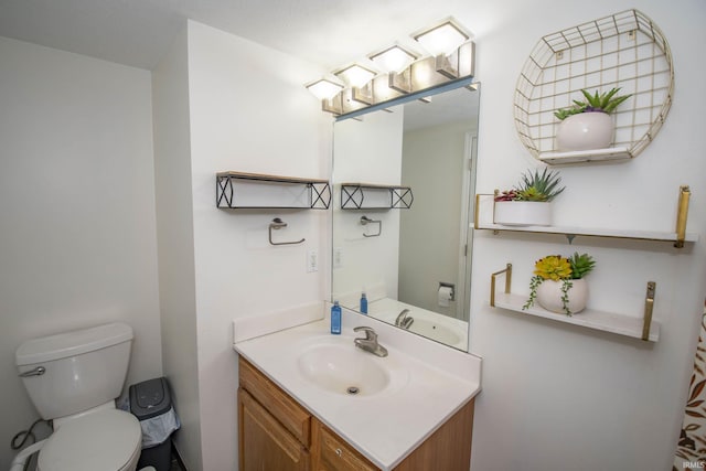 bathroom featuring toilet and vanity