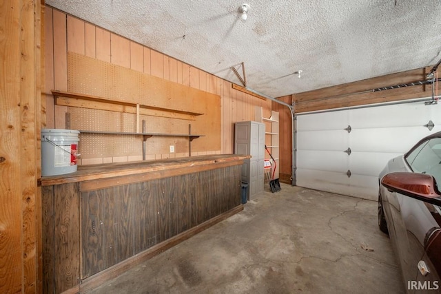 garage featuring wood walls