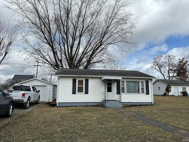 view of front of property with a front yard and an outdoor structure