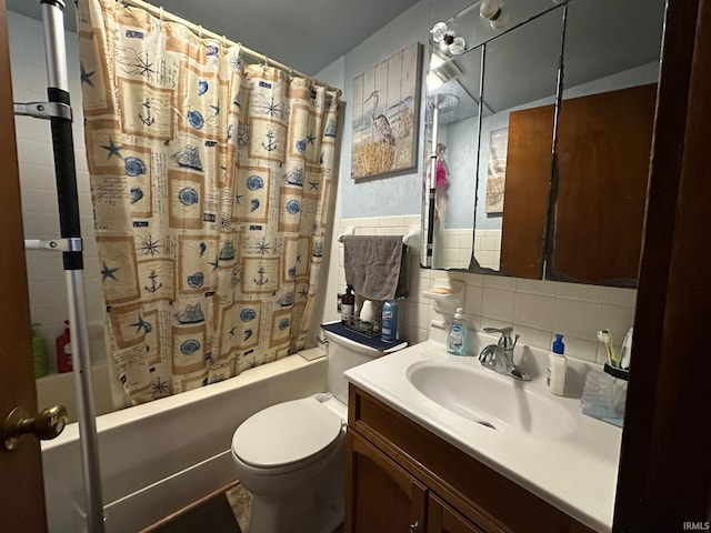 bathroom featuring shower / tub combo, tile walls, toilet, and vanity