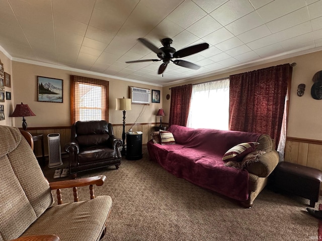 carpeted living area featuring ornamental molding, a wall mounted air conditioner, wainscoting, and wooden walls