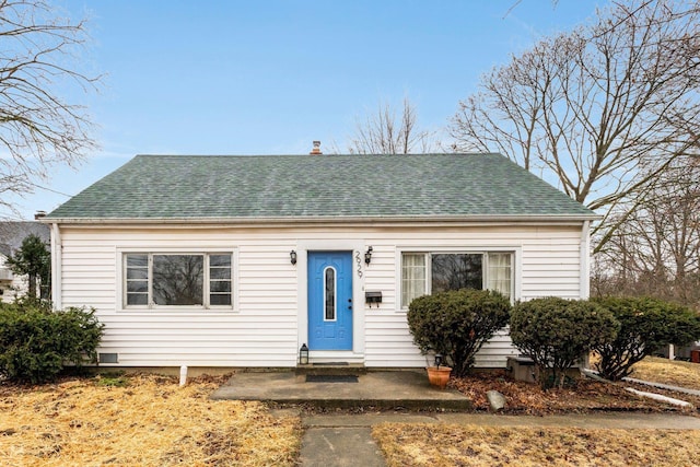 bungalow-style house featuring entry steps and roof with shingles