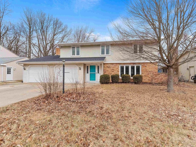 traditional-style house with driveway, brick siding, and an attached garage