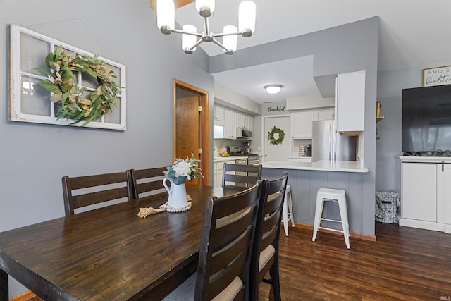 dining area featuring a chandelier and dark wood finished floors