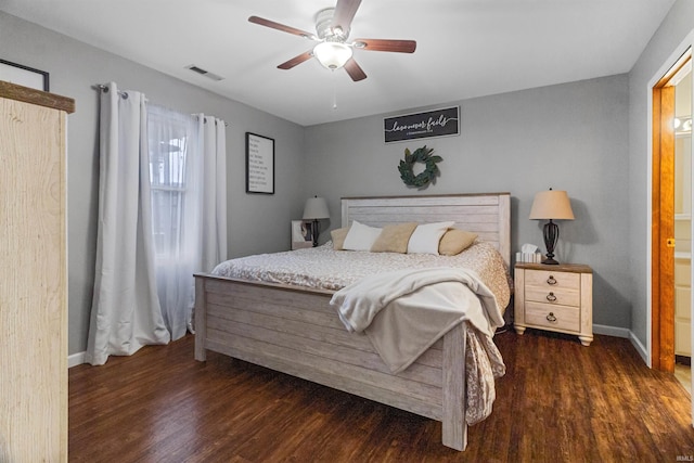 bedroom featuring a ceiling fan, wood finished floors, visible vents, and baseboards