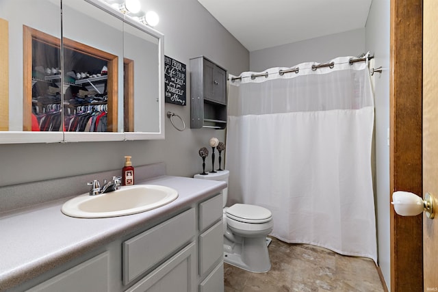 bathroom featuring toilet, curtained shower, and vanity