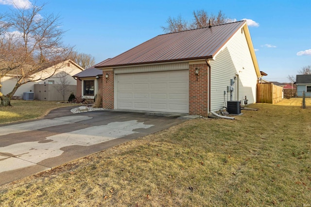 view of front of home featuring driveway, metal roof, fence, central air condition unit, and brick siding