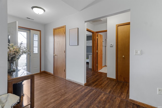 entrance foyer with wood finished floors, visible vents, and baseboards