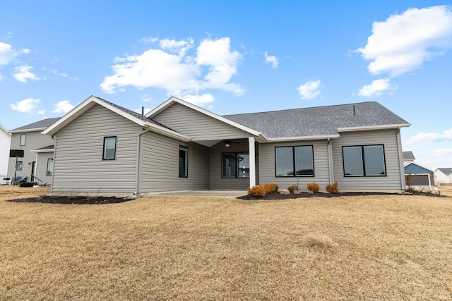 view of front of property with a patio area and a front lawn