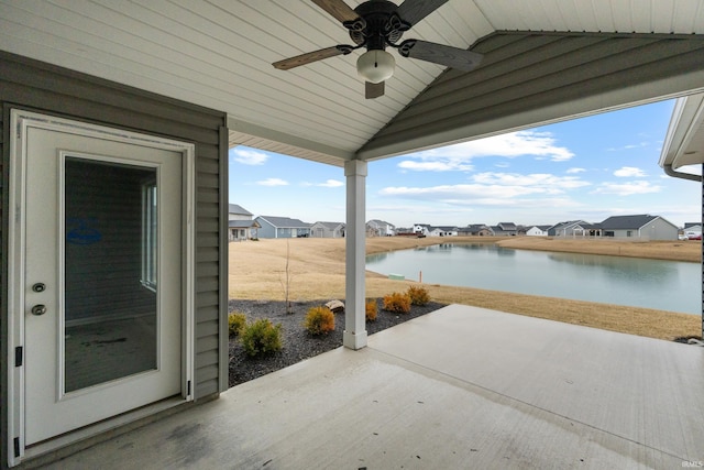 view of patio featuring a residential view, a water view, and ceiling fan