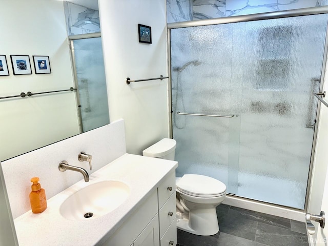 full bathroom featuring toilet, a shower stall, and vanity