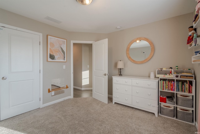 unfurnished bedroom featuring light colored carpet, visible vents, and baseboards