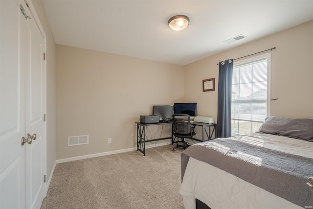 bedroom with carpet, visible vents, and baseboards