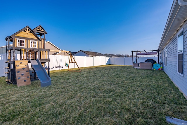 view of yard with a fenced backyard and a playground