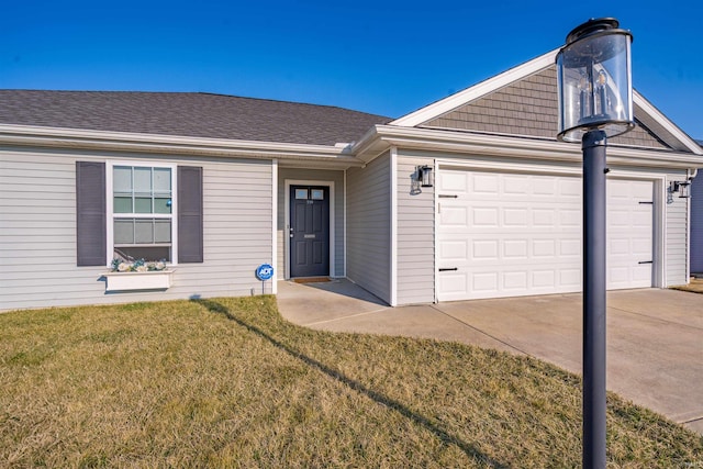 ranch-style home featuring a garage, driveway, a shingled roof, and a front yard