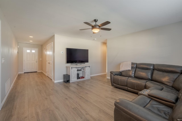 living room with light wood-type flooring, baseboards, a ceiling fan, and recessed lighting