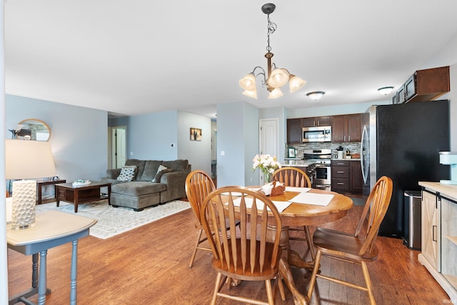 dining room with a chandelier and wood finished floors