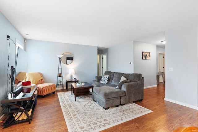 living room featuring wood finished floors and baseboards