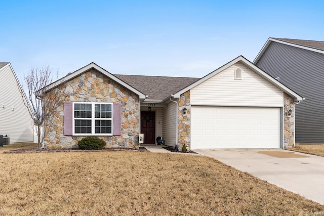 single story home with an attached garage, cooling unit, a shingled roof, driveway, and a front lawn