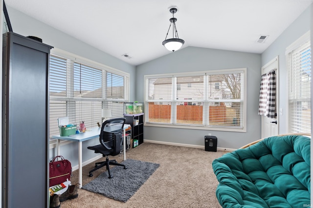 carpeted office space with lofted ceiling, visible vents, and plenty of natural light