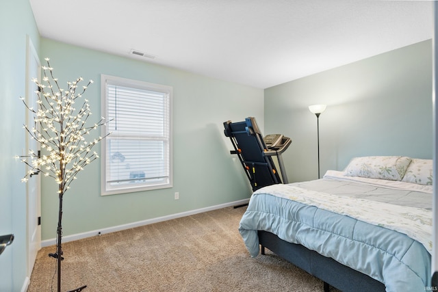 bedroom featuring carpet floors, visible vents, and baseboards