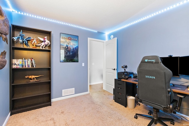 home office featuring carpet, visible vents, and baseboards