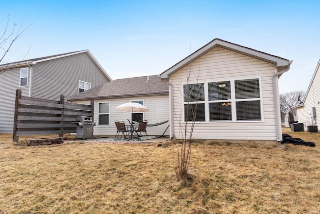 rear view of property with a patio area, fence, cooling unit, and a yard