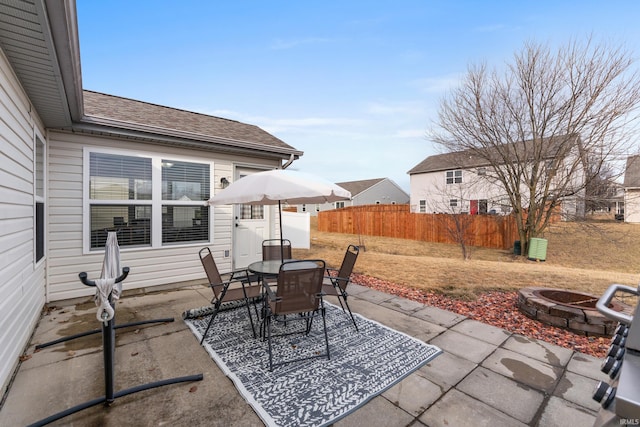 view of patio featuring a fire pit, fence, and outdoor dining area