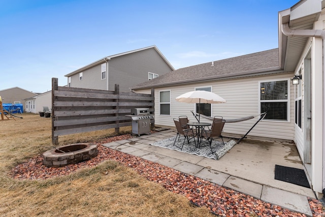 view of patio / terrace with an outdoor fire pit, grilling area, and fence