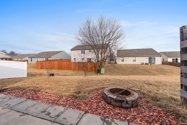 view of yard with fence and a fire pit