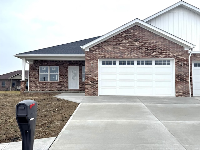 single story home with a garage, concrete driveway, brick siding, and roof with shingles