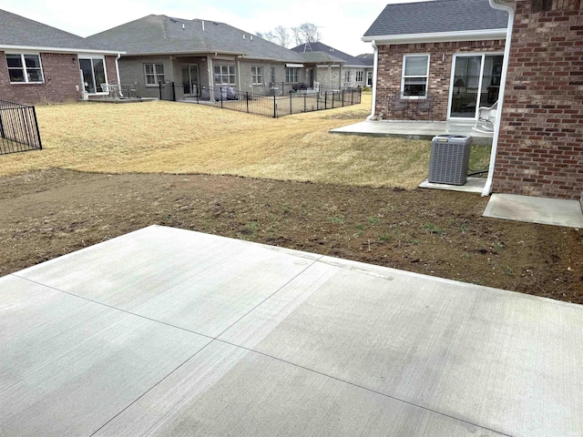 view of yard featuring central air condition unit, fence, and a patio