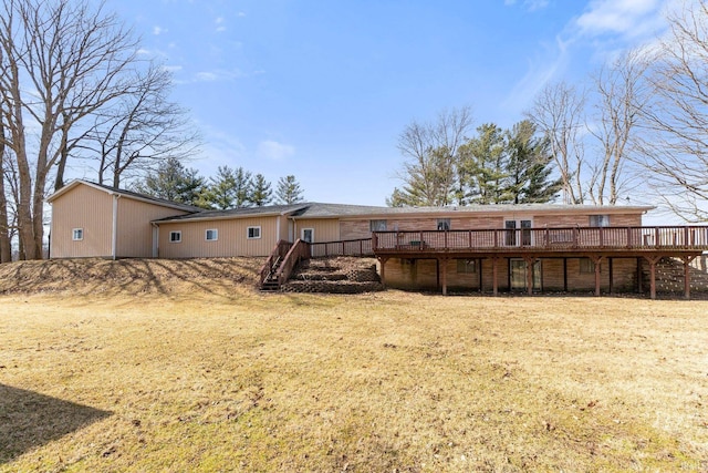 back of property with a deck and stairway