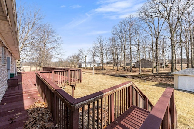 deck featuring a lawn and an outbuilding