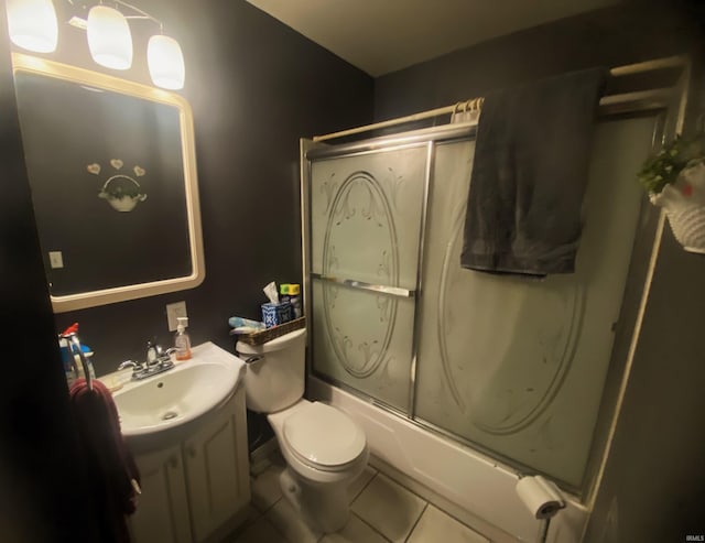 full bath with toilet, tile patterned flooring, bath / shower combo with glass door, and vanity