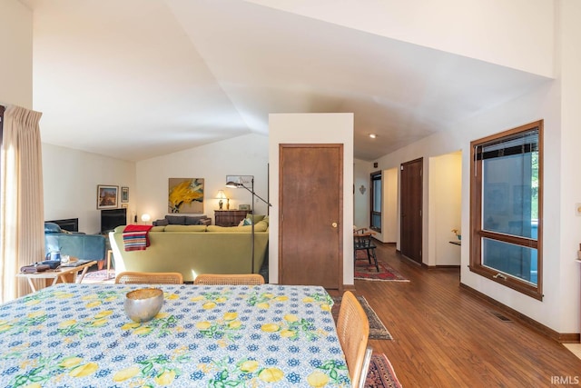 bedroom featuring visible vents, vaulted ceiling, baseboards, and wood finished floors