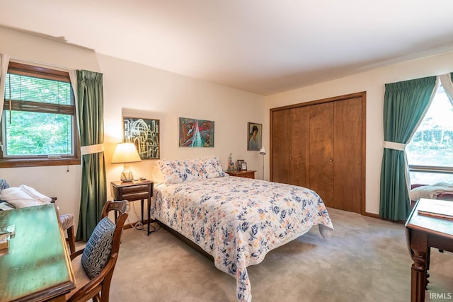 bedroom with a closet and light colored carpet