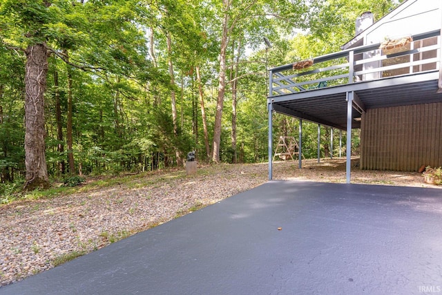 view of patio / terrace with stairs, a carport, and a wooden deck