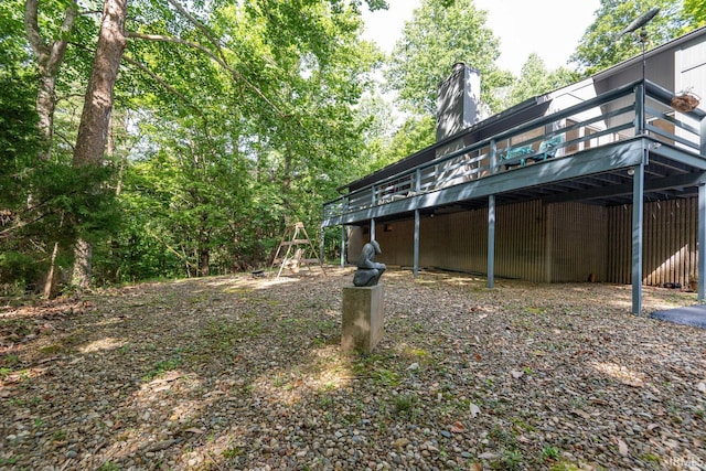 view of yard with a carport and a wooden deck