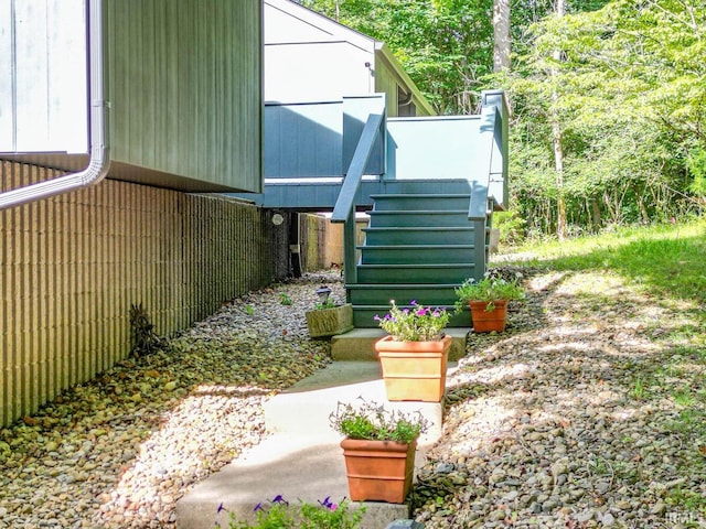 view of side of home featuring stairs